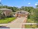 Charming home with lush front lawn and a brick-lined driveway leading to a spacious two-car garage at 10514 Scenic Hollow Dr, Riverview, FL 33578