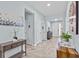 Bright hallway with tile flooring leading to a formal living room and other rooms at 10514 Scenic Hollow Dr, Riverview, FL 33578