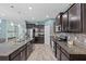 Spacious kitchen boasts dark cabinets, stainless steel appliances, and a stylish island at 10514 Scenic Hollow Dr, Riverview, FL 33578