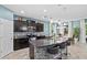 Island kitchen with dark cabinetry, granite countertops, and stainless steel appliances at 10514 Scenic Hollow Dr, Riverview, FL 33578