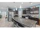 Gourmet kitchen with dark cabinets, stainless steel appliances, and a granite island at 10514 Scenic Hollow Dr, Riverview, FL 33578