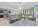 Spacious living area with a modern kitchen, comfortable gray sectional sofa, and stylish decor for entertaining guests at 10514 Scenic Hollow Dr, Riverview, FL 33578