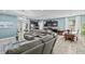 Open-concept living space with a modern kitchen, dining area, and a comfortable gray sectional sofa, perfect for entertaining at 10514 Scenic Hollow Dr, Riverview, FL 33578