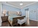 Bright and inviting main bedroom with hardwood floors and tray ceiling at 10514 Scenic Hollow Dr, Riverview, FL 33578