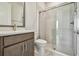 Stylish bathroom featuring a glass-enclosed shower, modern fixtures, and a sleek vanity with ample storage at 10712 Oak Bend Dr, Parrish, FL 34219
