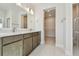 Bright bathroom featuring double vanity, tile flooring, walk-in closet, and glass-enclosed shower at 10712 Oak Bend Dr, Parrish, FL 34219