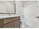 Modern bathroom with sleek vanity, stylish mirror, and shower-tub combo at 10712 Oak Bend Dr, Parrish, FL 34219