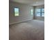 Spacious primary bedroom features neutral carpet, recessed lights, and plenty of windows at 10712 Oak Bend Dr, Parrish, FL 34219