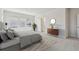 Bright bedroom features large windows, ensuite bathroom access, and neutral decor at 10712 Oak Bend Dr, Parrish, FL 34219