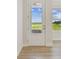 Inviting entryway with a glass-paneled door offering abundant natural light and views of the lush surroundings at 10712 Oak Bend Dr, Parrish, FL 34219