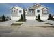 Modern townhomes featuring two-car garages and stylish gray and tan exteriors at 10712 Oak Bend Dr, Parrish, FL 34219