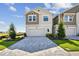 Two-story home featuring a paver driveway, two-car garage, manicured lawn, and neutral color scheme at 10712 Oak Bend Dr, Parrish, FL 34219