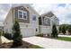 Exterior view of townhomes with gray and beige facades, well-manicured lawns, and brick-paved driveways at 10712 Oak Bend Dr, Parrish, FL 34219