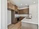 Kitchen featuring stainless steel appliances, a center island, wood cabinetry, and tile backsplash at 10712 Oak Bend Dr, Parrish, FL 34219
