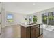 Bright kitchen with stainless appliances, wood cabinets, island, and large windows at 10712 Oak Bend Dr, Parrish, FL 34219