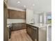 Modern kitchen with stainless steel appliances, wood cabinets, white backsplash, and center island at 10712 Oak Bend Dr, Parrish, FL 34219