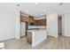 Bright open kitchen with stainless steel appliances, island, wood cabinets, and recessed lighting at 10712 Oak Bend Dr, Parrish, FL 34219