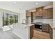 Bright kitchen with a stainless steel appliances, wood cabinets, subway tile backsplash, and large island at 10712 Oak Bend Dr, Parrish, FL 34219