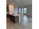 This bright kitchen features an island, stainless appliances, and durable hard surface floors at 10712 Oak Bend Dr, Parrish, FL 34219