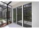 Lanai with screens, tile flooring, and a tranquil view of tropical landscaping at 10712 Oak Bend Dr, Parrish, FL 34219
