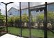 Spacious lanai with a view of lush greenery, shrubbery, and construction at 10712 Oak Bend Dr, Parrish, FL 34219