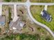 Aerial view of the home showcasing a large lot, mature trees, lush landscaping, and a swimming pool at 11296 Warm Wind Way, Weeki Wachee, FL 34613