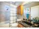 Bathroom features a bathtub and shower combo, dark countertop, and a hanging mirror at 11296 Warm Wind Way, Weeki Wachee, FL 34613