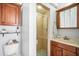 Bathroom featuring single sink vanity, cabinet storage, and shower behind glass door at 11296 Warm Wind Way, Weeki Wachee, FL 34613