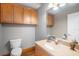 Well-lit bathroom with granite countertop, decorative fixtures and wooden cabinets at 11296 Warm Wind Way, Weeki Wachee, FL 34613