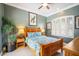 Comfortable bedroom featuring shuttered windows, light green walls, and wood furniture at 11296 Warm Wind Way, Weeki Wachee, FL 34613