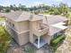 Exterior view of the home featuring a private balcony and lush landscaping in a residential neighborhood at 11296 Warm Wind Way, Weeki Wachee, FL 34613