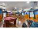 Large game room with a pool table, custom lighting, and a rustic bar for entertaining at 11296 Warm Wind Way, Weeki Wachee, FL 34613