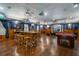 Spacious game room with a pool table and rustic bar tables for entertaining guests at 11296 Warm Wind Way, Weeki Wachee, FL 34613