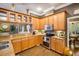 Kitchen with stainless steel appliances and wooden cabinetry at 11296 Warm Wind Way, Weeki Wachee, FL 34613