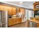 Kitchen with stainless steel appliances and wooden cabinets at 11296 Warm Wind Way, Weeki Wachee, FL 34613