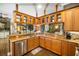 Kitchen with wooden cabinets, granite countertops, and stainless steel appliances at 11296 Warm Wind Way, Weeki Wachee, FL 34613