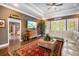 Comfortable living room featuring a plush sofa, hardwood floors, a large area rug, and a view to the foyer at 11296 Warm Wind Way, Weeki Wachee, FL 34613