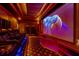 Home theater featuring tiered seating, projector, and large screen for immersive movie nights at 11296 Warm Wind Way, Weeki Wachee, FL 34613