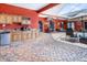 Outdoor kitchen with stone countertops, cabinets, and a mini fridge at 11296 Warm Wind Way, Weeki Wachee, FL 34613