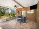 Enclosed patio with a TV and a bar that is ideal for watching sports or enjoying a drink at 11296 Warm Wind Way, Weeki Wachee, FL 34613