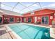 Spacious pool with an orange exterior and a covered patio and an outdoor bar is perfect for entertaining at 11296 Warm Wind Way, Weeki Wachee, FL 34613