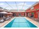 Inviting pool area with ample lounge seating, an outdoor kitchen, a bar, and a covered patio at 11296 Warm Wind Way, Weeki Wachee, FL 34613