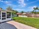 Spacious backyard featuring a manicured lawn and brick patio, offering a serene outdoor space at 12327 Glenfield Ave, Tampa, FL 33626