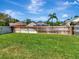 Expansive green backyard enclosed by a wooden fence providing privacy and ample space at 12327 Glenfield Ave, Tampa, FL 33626