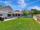 Backyard featuring a lush lawn, a patio, and a screened-in porch for comfortable outdoor living at 12327 Glenfield Ave, Tampa, FL 33626