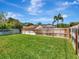 Wide backyard with a well-kept lawn and a privacy fence for outdoor enjoyment at 12327 Glenfield Ave, Tampa, FL 33626