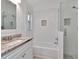 Bathroom featuring granite countertops, white subway tile, and a glass-enclosed shower at 12327 Glenfield Ave, Tampa, FL 33626