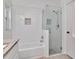 Bathroom featuring a tub and a glass-enclosed shower at 12327 Glenfield Ave, Tampa, FL 33626