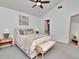 Bedroom with neutral decor, a ceiling fan, and easy access to the bathroom at 12327 Glenfield Ave, Tampa, FL 33626