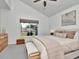 Bedroom featuring neutral colors, large windows overlooking the backyard, and a comfy bench at 12327 Glenfield Ave, Tampa, FL 33626